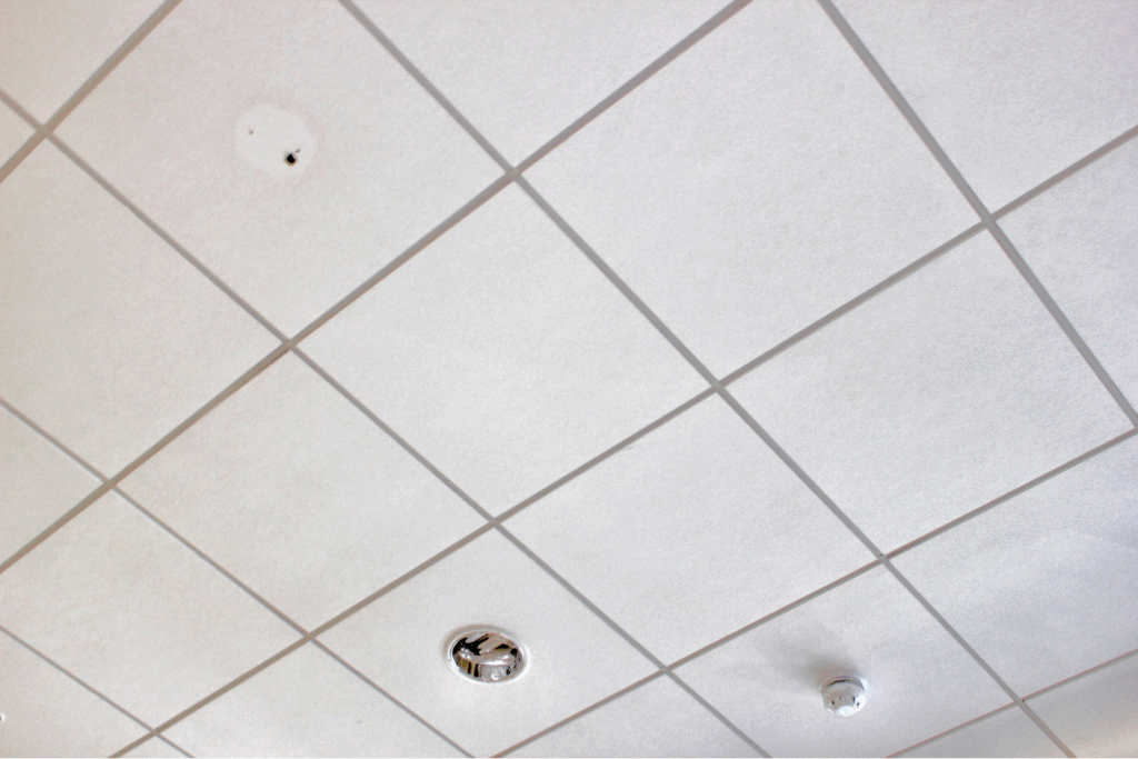 Suspended gypsum ceiling tiles with lighting and smoke detector
